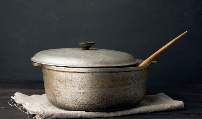 Aluminum pan with spoon on counter