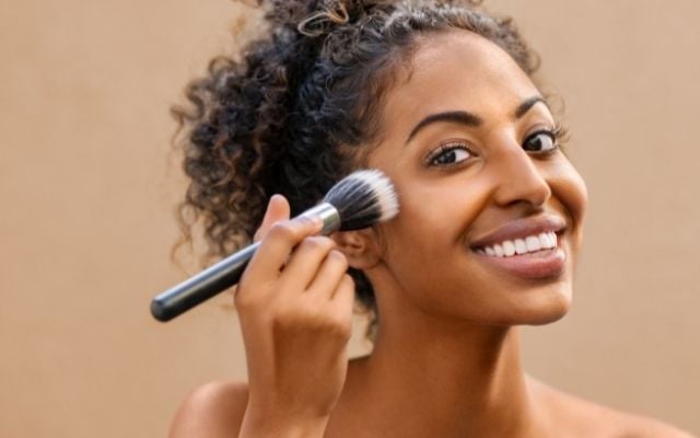 woman applying makeup