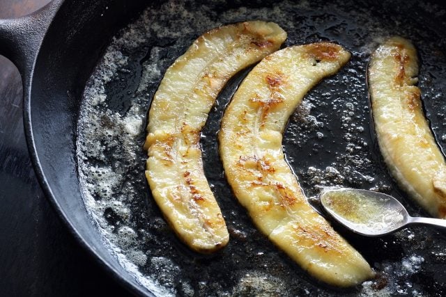 Fried bananas in a non-stick cast iron pan